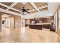 Open-concept kitchen and living area with tile floors and coffered ceilings at 8109 Mountain Forest Ct, Las Vegas, NV 89129