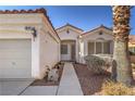 Front view of house with walkway, single-car garage, and landscaping at 10649 Bella Ordaz Way, Las Vegas, NV 89141