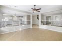 Open living area with tile floors and a view of the kitchen and staircase at 10923 Royal Highlands St, Las Vegas, NV 89141