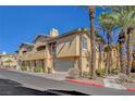 Tan two-story building with attached garages at 1700 Hills Of Red Dr # 202, Las Vegas, NV 89128