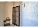 Front door entrance with security door and small table at 2173 Aspen Mirror Way # 101, Laughlin, NV 89029