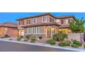 Tan house with shutters, stone accents and a three-car garage at 2920 Josephine Dr, Henderson, NV 89044