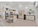 Well-lit kitchen featuring an island with seating, stainless steel appliances, and ample cabinetry at 5915 Ablette Ave, Las Vegas, NV 89122