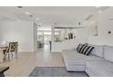 Open floor plan connecting the living room and kitchen with hardwood floors at 5915 Ablette Ave, Las Vegas, NV 89122
