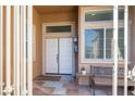 White front door entry with sidelights and a small bench at 6083 Dunham Hills Way, Las Vegas, NV 89113