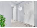 Inviting foyer with white tile flooring, a decorative circular window, and neutral paint at 6250 W Flamingo Rd # 98, Las Vegas, NV 89103