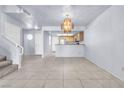Spacious living area features tile flooring, chandelier, and stairs to the second level at 6250 W Flamingo Rd # 98, Las Vegas, NV 89103