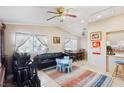 Inviting living room featuring comfortable seating, neutral walls, natural light, and a ceiling fan at 6409 Youngmont Ave, Las Vegas, NV 89103