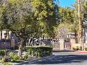 Gated entrance to Ironwood Condominiums community with lush landscaping at 8309 Cherry Glaze Ave # 201, Las Vegas, NV 89145