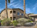 Exterior of a condominium with lush landscaping, palm trees, and covered parking at 8985 S Durango Dr # 2062, Las Vegas, NV 89113