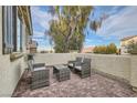 Private back patio with brick pavers and comfortable seating, perfect for relaxing at 1189 Hillside Peak St, Henderson, NV 89002