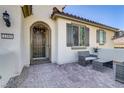 Inviting front entrance featuring wrought iron gate and a cozy seating area at 1189 Hillside Peak St, Henderson, NV 89002