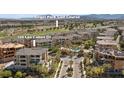 An aerial view of a luxurious community showcasing lush landscaping and a nearby golf course at 120 Los Cabos Dr # 301, Las Vegas, NV 89144