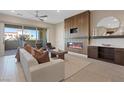 An inviting living room features a fireplace, modern furniture, and access to a private patio at 120 Los Cabos Dr # 301, Las Vegas, NV 89144