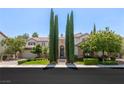 Stunning two-story home with manicured lawn and tall trees at 1975 Alcova Ridge Dr, Las Vegas, NV 89135