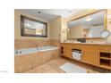 Bathroom with double vanity, soaking tub, and large mirror at 2000 N Fashion Show Dr # 3709, Las Vegas, NV 89109