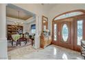 Inviting foyer boasting a wood door, marble floors, and a view of the formal dining area at 215 Granite Ct, Boulder City, NV 89005