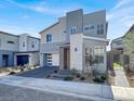 Modern two-story home featuring a brick driveway, a two-car garage, and professionally landscaped front yard at 3197 Vittoria Ave, Henderson, NV 89044