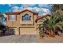 Inviting two-story home featuring a terracotta tile roof, spacious garages, and desert landscaping at 395 Suzanne Peak Ct, Henderson, NV 89012