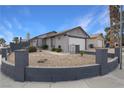 Single story home with a curved driveway and desert landscaping at 4401 Mossy Rock Ct, Las Vegas, NV 89108