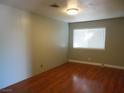 Bedroom with hardwood floors, a window, and neutral paint at 6786 Grandola Dr, Las Vegas, NV 89103