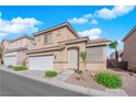 Charming two-story home featuring a two-car garage and desert landscaping against a backdrop of a blue sky and white clouds at 10412 Timber Canyon Ave, Las Vegas, NV 89129