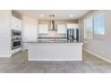 Well-lit kitchen with an island, modern appliances, and ample storage at 1835 Kinglake St, Henderson, NV 89044