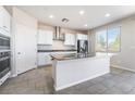 Bright kitchen featuring a central island, sleek appliances, and modern finishes at 1835 Kinglake St, Henderson, NV 89044