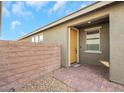 Inviting front entry with a yellow door and brick walkway at 2261 Cold Canyon Ave, North Las Vegas, NV 89086