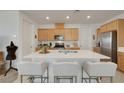 Modern kitchen with light wood cabinets, a large island, and stainless steel appliances at 2261 Cold Canyon Ave, North Las Vegas, NV 89086