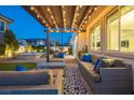 Inviting covered back patio with comfortable seating and string lights, perfect for outdoor relaxation and entertaining at 3372 Dalmore St, Henderson, NV 89044