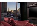 Modern living room featuring comfortable seating and a floor to ceiling window with a stunning city view at 3726 Las Vegas Blvd # 1101, Las Vegas, NV 89158