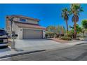 Front view of a two-story house with a gray door at 4773 Sarazen Cir, Las Vegas, NV 89103