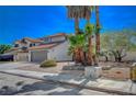 House with palm trees and a gray garage door at 4773 Sarazen Cir, Las Vegas, NV 89103