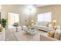 Staged living room featuring neutral walls, light-toned floors, and stylish modern furniture at 523 Painted Cloud Pl, Las Vegas, NV 89144