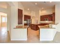 Open kitchen with granite counters and breakfast bar at 6412 Moss Agate Dr, Las Vegas, NV 89131