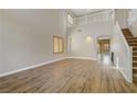 Spacious living room featuring high ceilings, wood floors, arched doorways, and natural light at 8005 Egypt Meadows Ave, Las Vegas, NV 89178