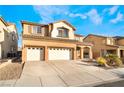 Two-story house with three-car garage and desert landscaping at 126 Cricklewood Ave, Henderson, NV 89002