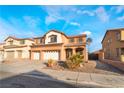 Two-story house with three-car garage and desert landscaping at 126 Cricklewood Ave, Henderson, NV 89002