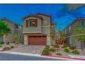 Two-story home with attached garage and landscaped yard at 176 Kimberlite Dr, Henderson, NV 89011