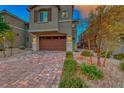 Brick paved driveway and two-story home exterior at 176 Kimberlite Dr, Henderson, NV 89011