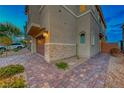 Side view of home showcasing stone accents and landscaping at 176 Kimberlite Dr, Henderson, NV 89011
