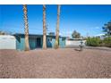 Charming single-story home with desert landscaping, palm trees, and a welcoming driveway at 1940 E Golden Arrow Dr, Las Vegas, NV 89169