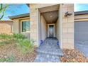 Inviting front entryway with stone walkway, desert landscaping, and a decorative door at 29 Sun Mirage Ave, Henderson, NV 89011
