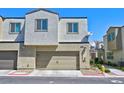 Two-car garage with modern door and street parking at 3634 Tripoli Cove Ave, Las Vegas, NV 89106