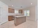 Kitchen featuring stainless steel appliances, an island, and tile flooring at 3634 Tripoli Cove Ave, Las Vegas, NV 89106