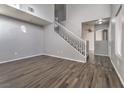 Living room with a white staircase and wood flooring at 3950 S Sandhill Rd # 112, Las Vegas, NV 89121