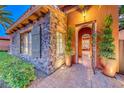 Close-up of front door with stone detail and wrought iron gate entry at 453 Via Palermo Dr, Henderson, NV 89011