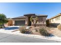 Beautiful single-story house with desert landscaping, a two-car garage, and a paved driveway at 5805 Hannah Brook St, North Las Vegas, NV 89081