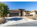 Attractive single-story home with desert landscaping, a two-car garage, and a welcoming entrance at 5805 Hannah Brook St, North Las Vegas, NV 89081
